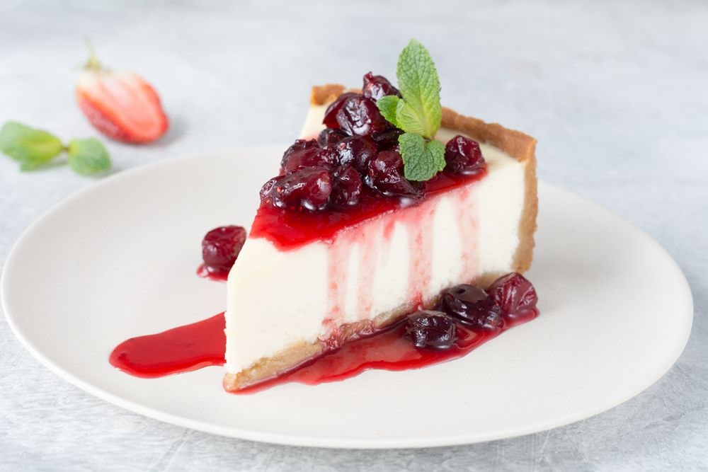 Slice of Cheesecake with a delicious Cranberry Topping - Recipe Included
