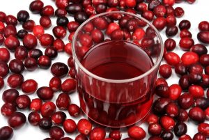 Pure red juice without any added sugar surrounded by cranberries.