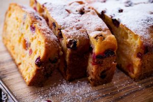 A tasty looking cranberry bread that is sliced and just came out of the oven.