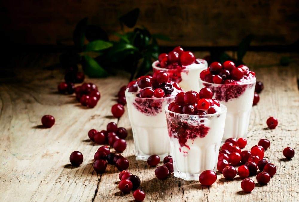 4 cups of vanilla ice cream topped with cranberry dessert topping.