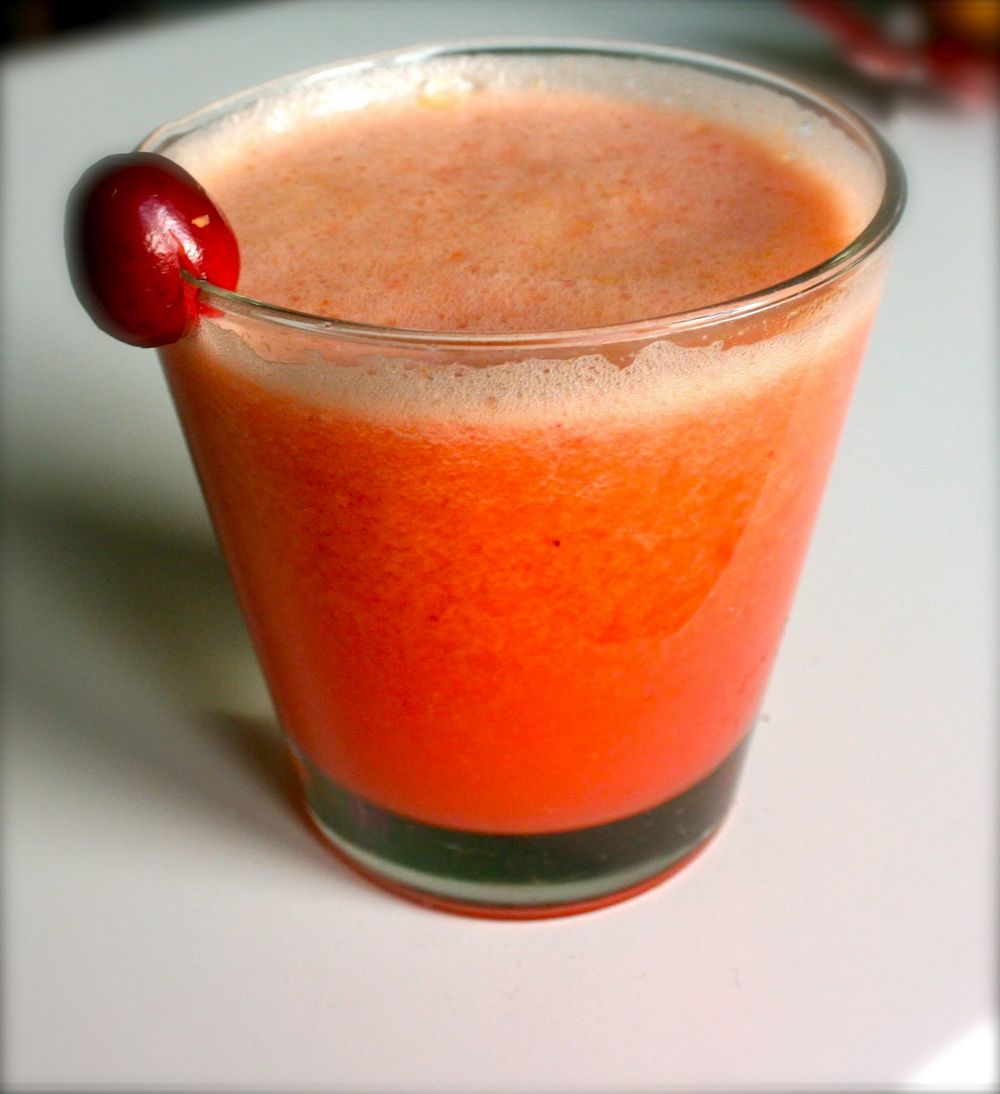 JUice made with cranberry, orange, apple, lemon and pear in a glass.