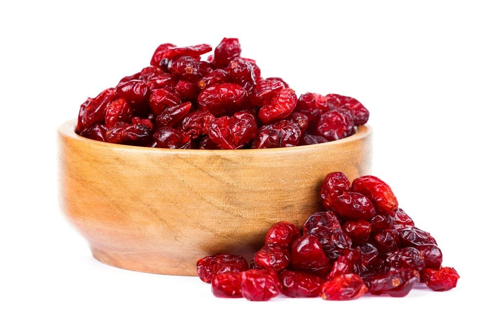 A big bowl of juicy dehydrated cranberries that look plump and juicy