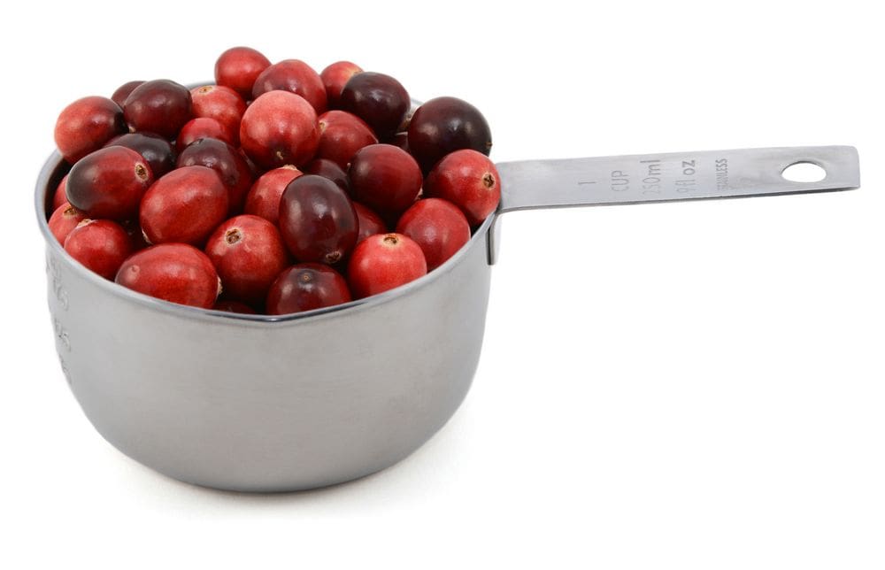 A Measuring cup of cranberries.
