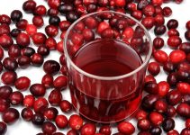 Pure red juice without any added sugar surrounded by cranberries.