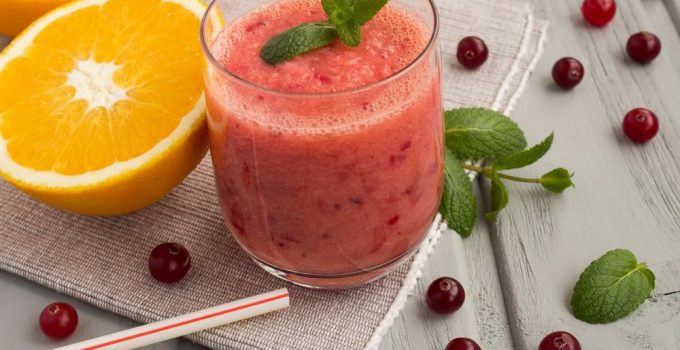 A blended fruit smoothie native citrus and ripe red berries.