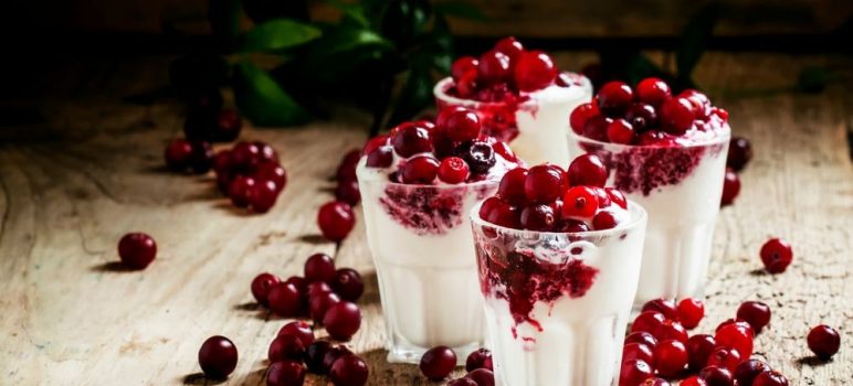 4 cups of vanilla ice cream topped with cranberry dessert topping.