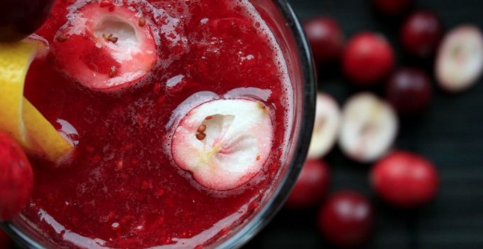 A delicious looking, bright red, fruit smoothie