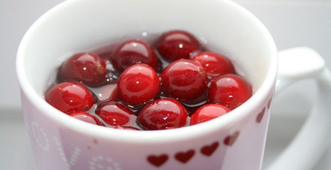 Homemade cranberry tea with berries floating on top