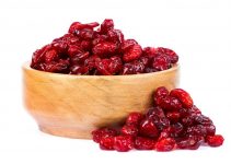 A big bowl of juicy dehydrated cranberries that look plump and juicy