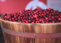 How many of these juicy red berries are contained in this wooden barrel?